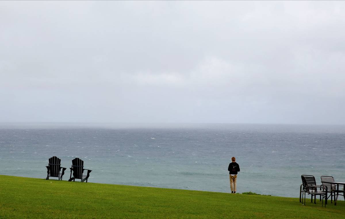 A person stands in front of the Pacific Ocean at The Cliffs at Princeville resort, one of sever ...