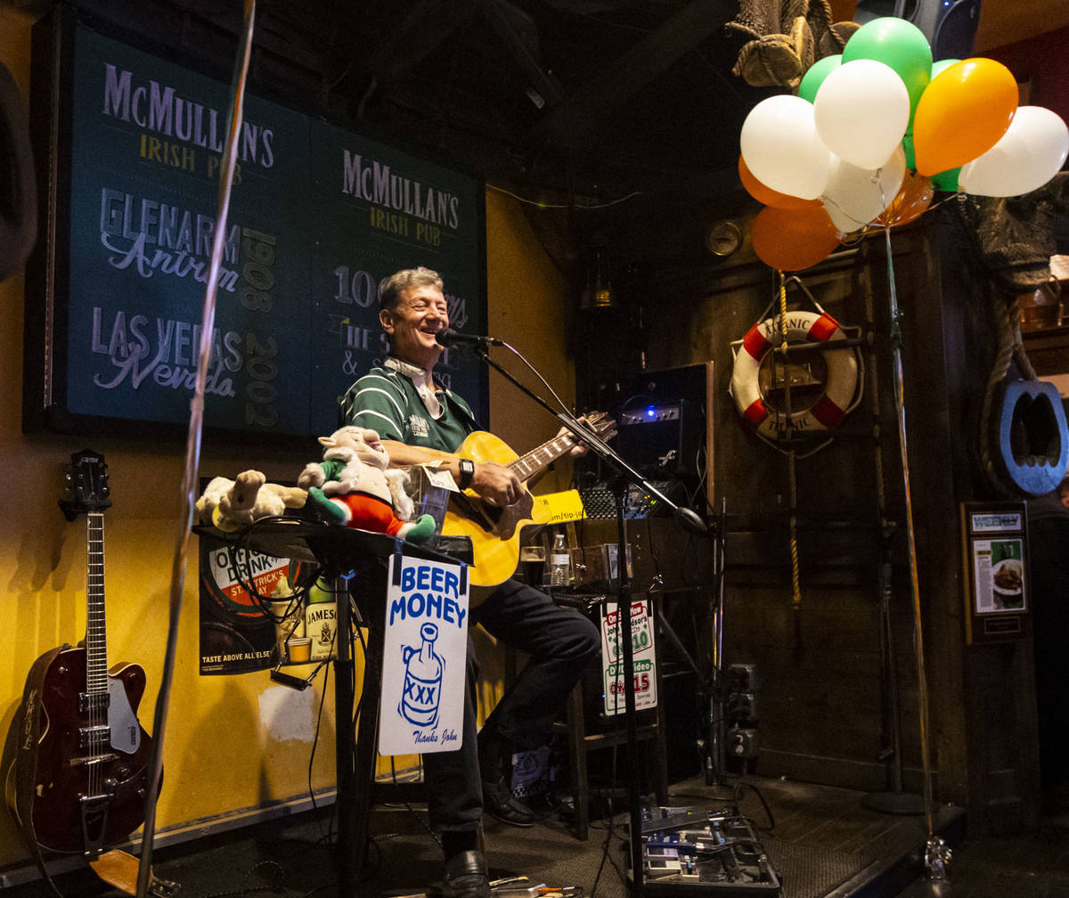 Musician John Windsor performs as people gather to celebrate St. Patrick's Day at McMullan's Ir ...