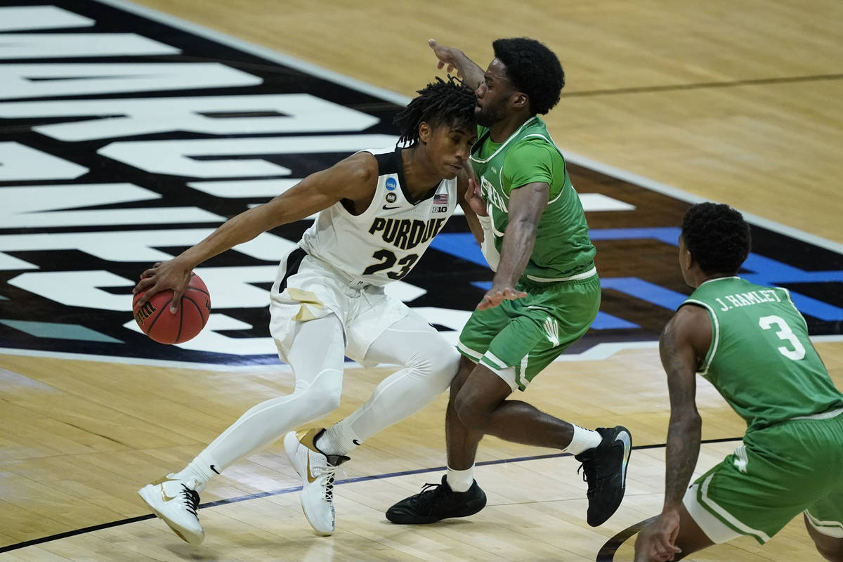 Purdue's Jaden Ivey (23) is defended by North Texas's JJ Murray (11) during the first half of a ...