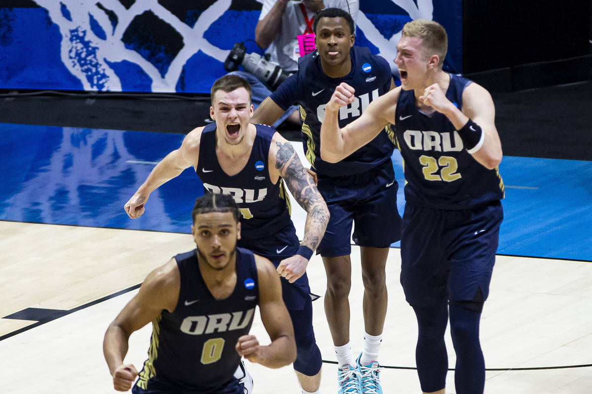 Oral Roberts players celebrate after beating Ohio State in a first-round game in the NCAA men's ...