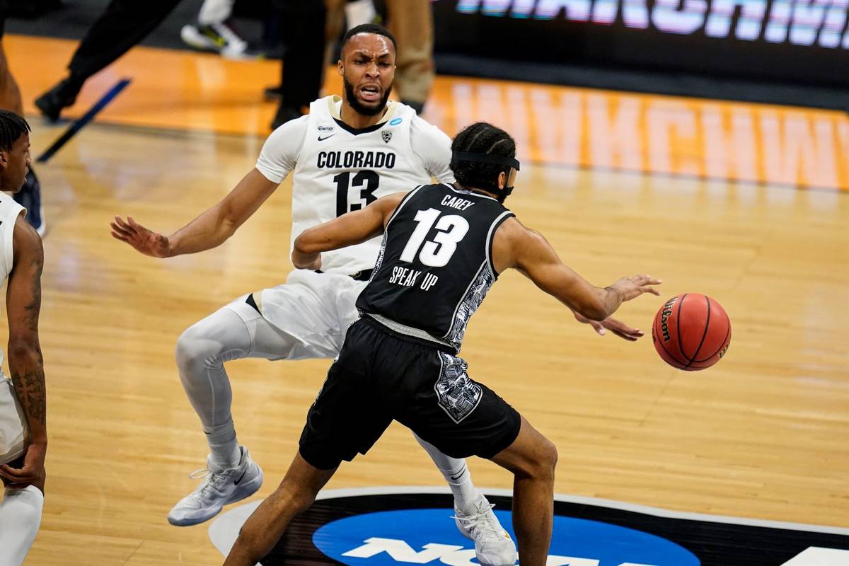 Colorado forward Dallas Walton (13) draws the charge from Georgetown guard Donald Carey (13) in ...