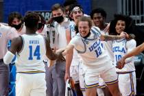 UCLA's Mac Etienne (12) slaps hands with Kenneth Nwuba (14) in the final moments of their 67-47 ...