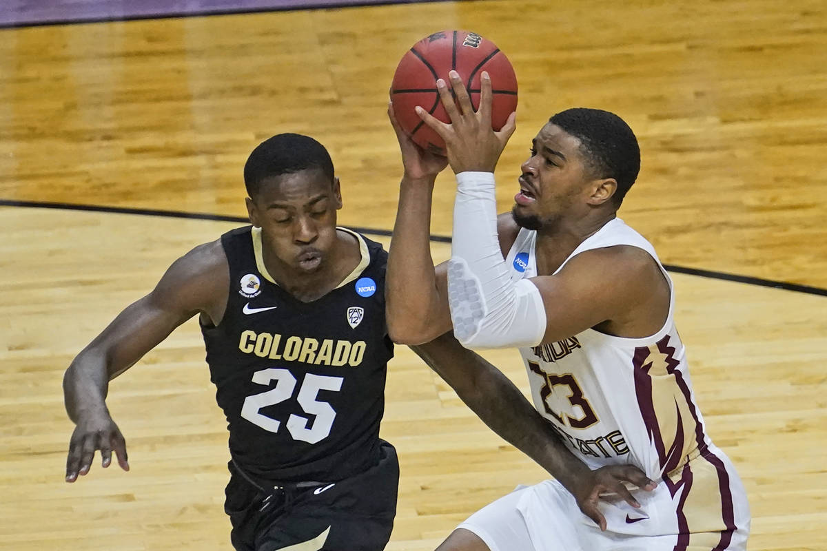 Florida State guard M.J. Walker (23) drives to the basket as Colorado guard McKinley Wright IV ...