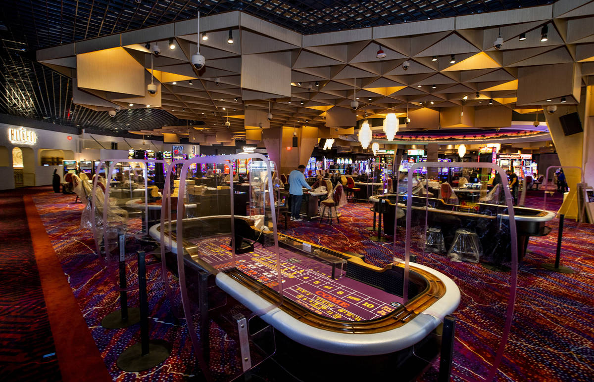 Much plexiglass will keep visitors separated between slots and table games in the main gambling ...