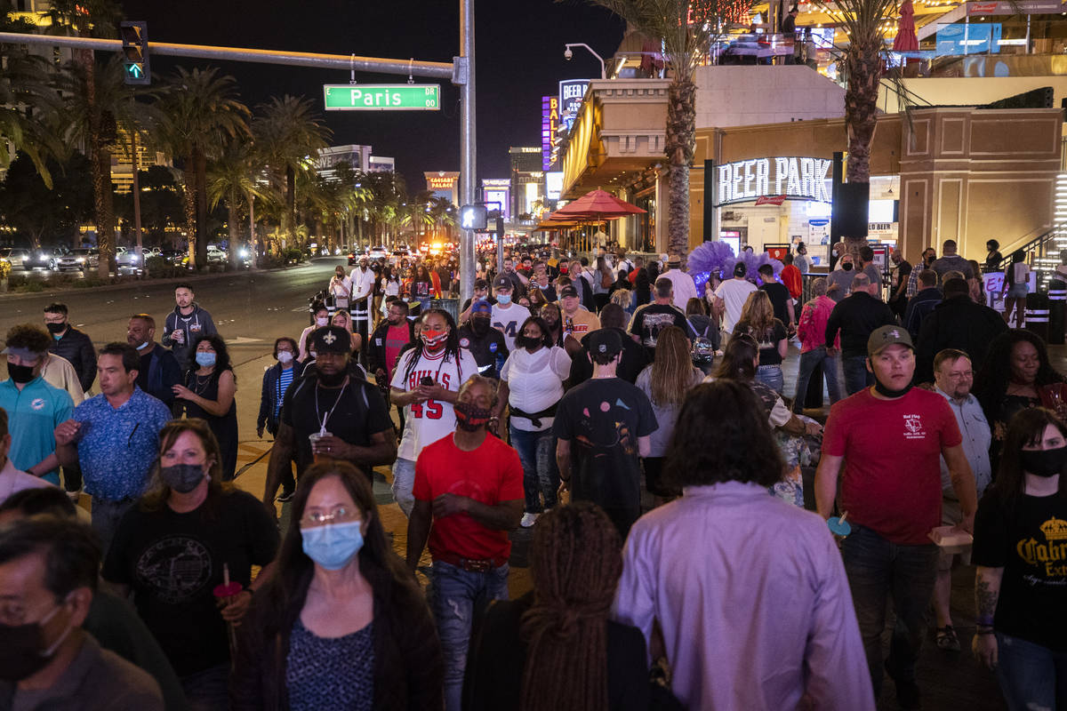 The Strip is packed outside Paris Las Vegas on Friday, March 19, 2021, in Las Vegas. (Benjamin . 