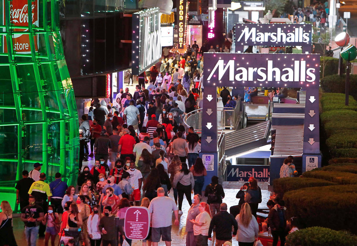 People walk along the Las Vegas Strip,, near Marshalls, Friday, March 19, 2021, in Las Vegas. ( . 