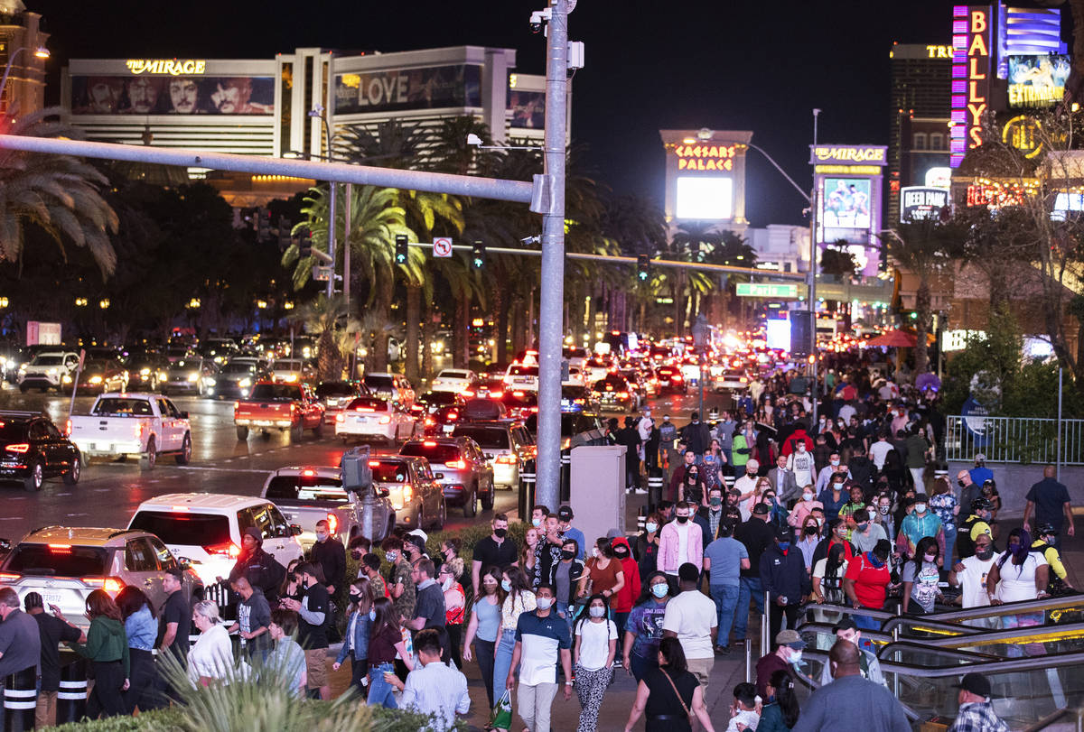 The Strip is packed outside Paris Las Vegas on Friday, March 19, 2021, in Las Vegas. (Benjamin ...