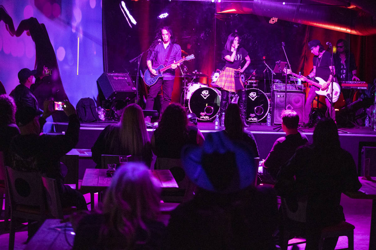 People watch a performance by the Heartbreakers inside of the newly opened Rockstar Bar at the ...