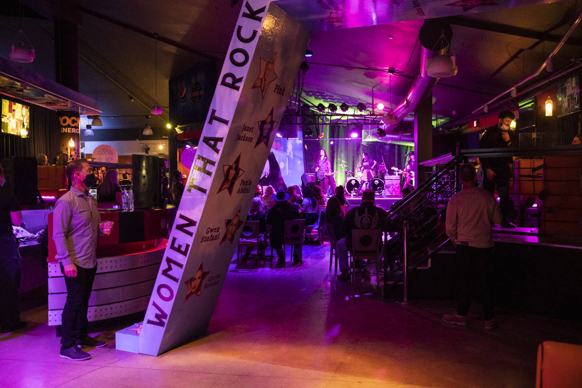 People watch a performance by the Heartbreakers inside of the newly opened Rockstar Bar at the ...