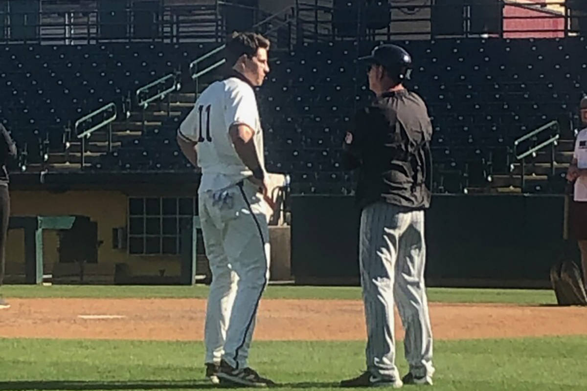 Kade Higgins, left, shares a moment with his father, Kevin, UNLV's associate baseball coach, af ...