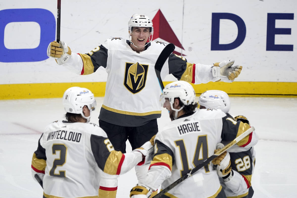 Vegas Golden Knights left wing Tomas Nosek, top, celebrates after assisting on a goal from Will ...