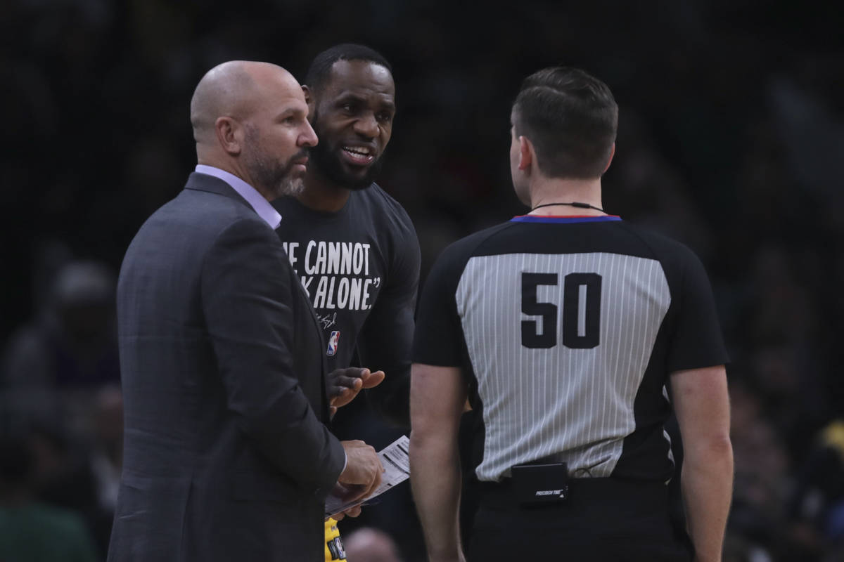 Los Angeles Lakers forward LeBron James, center, and coach Jason Kidd talk with referee Gedimin ...