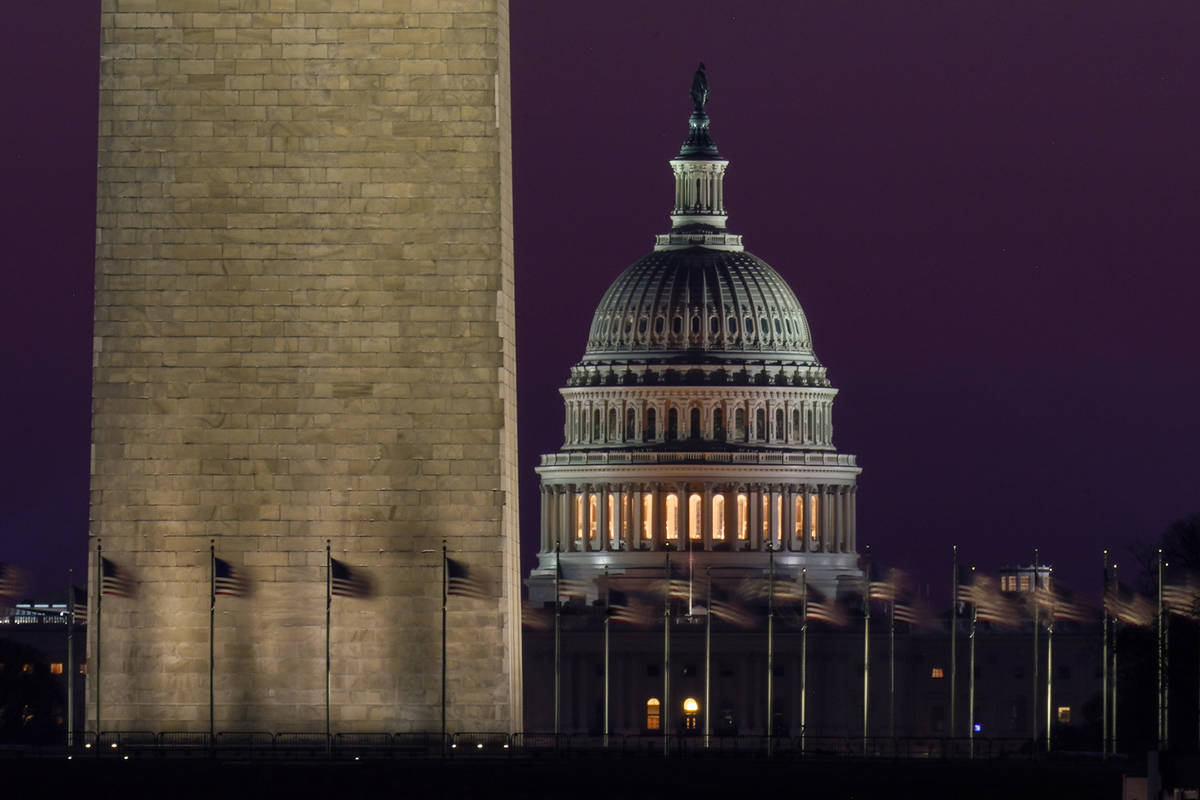 The Capitol is seen beyond the base of the Washington Monument before sunrise in Washington, We ...