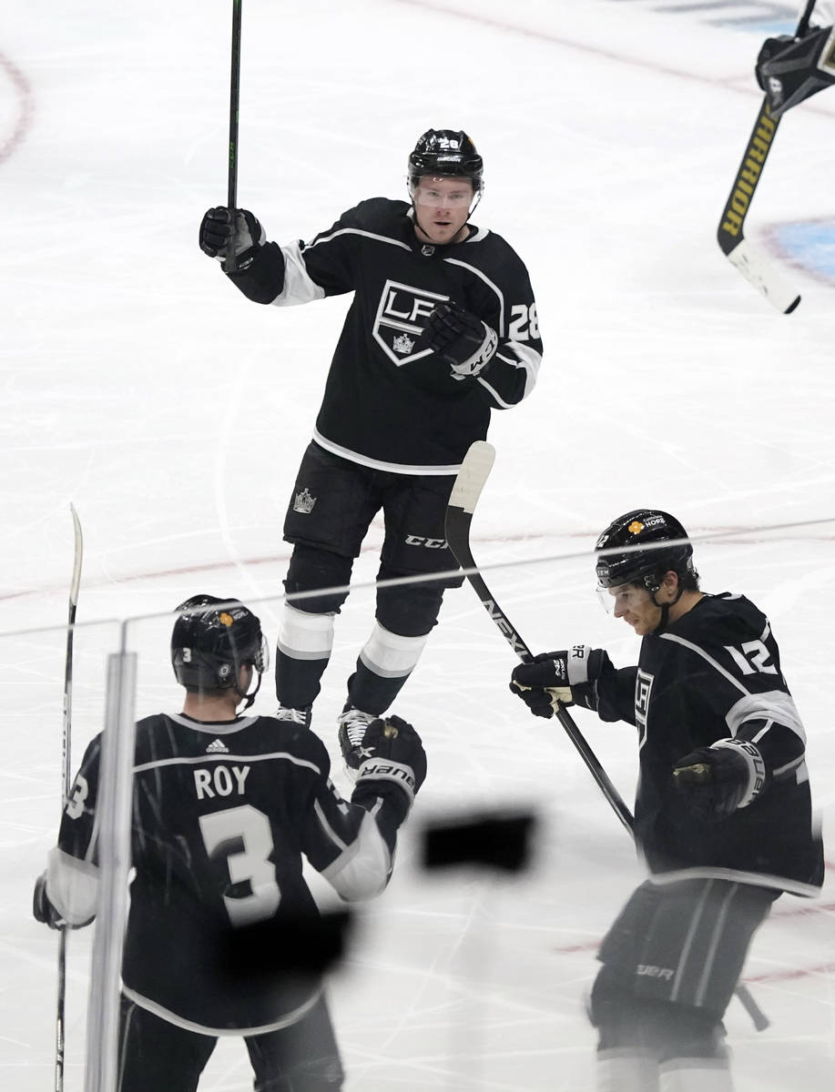Los Angeles Kings center Trevor Moore (12) celebrates his goal with Matt Roy (3) and Jaret Ande ...