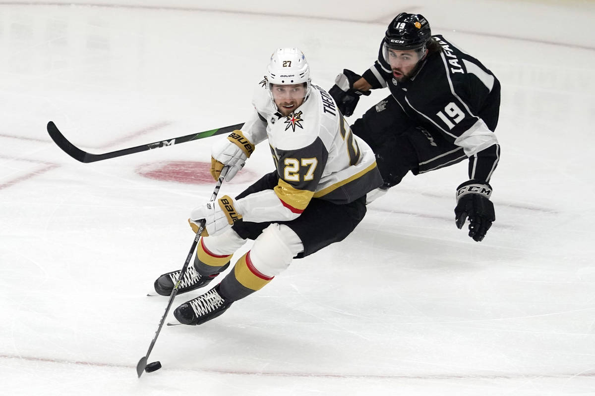 Vegas Golden Knights defenseman Shea Theodore (27) is chased by Los Angeles Kings left wing Ale ...