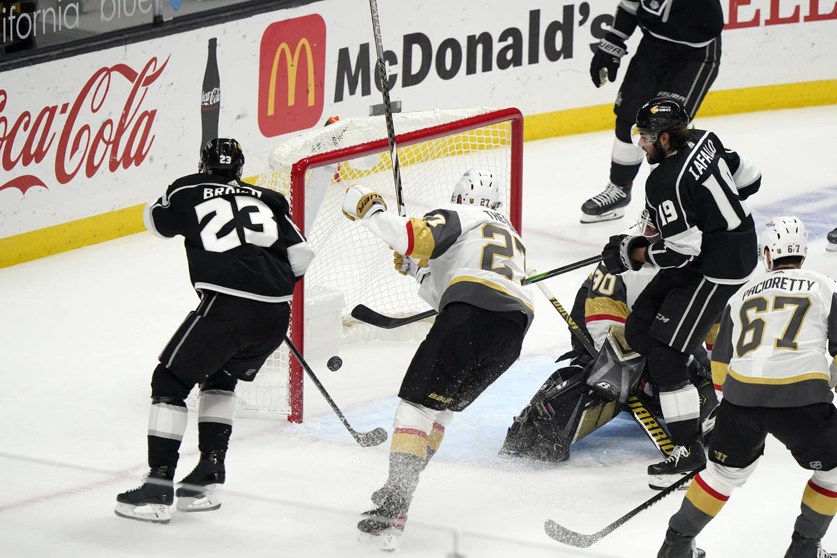 Los Angeles Kings left wing Alex Iafallo, right, scores during the first period of the team's N ...