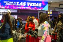 Visitors to Las Vegas, wearing personal protective equipment to prevent the spread of COVID-19, ...