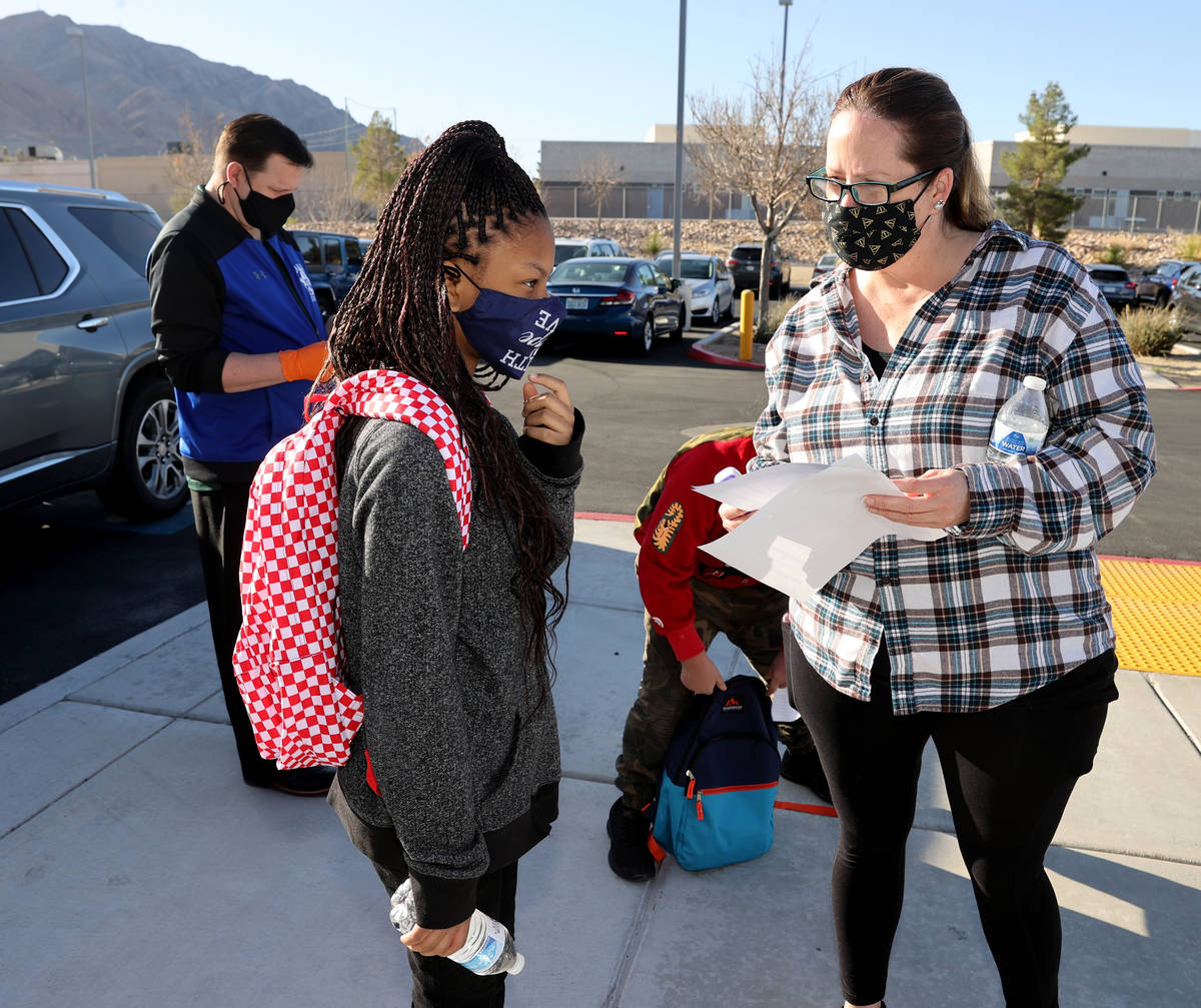Teacher/lLibrarian Shannon Fowler helps sixth grader Aaliyah Kemp find her first class on the f ...