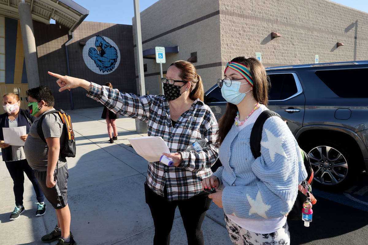 Teacher/lLibrarian Shannon Fowler helps sixth grader Tiffany Andrews find her first class on th ...