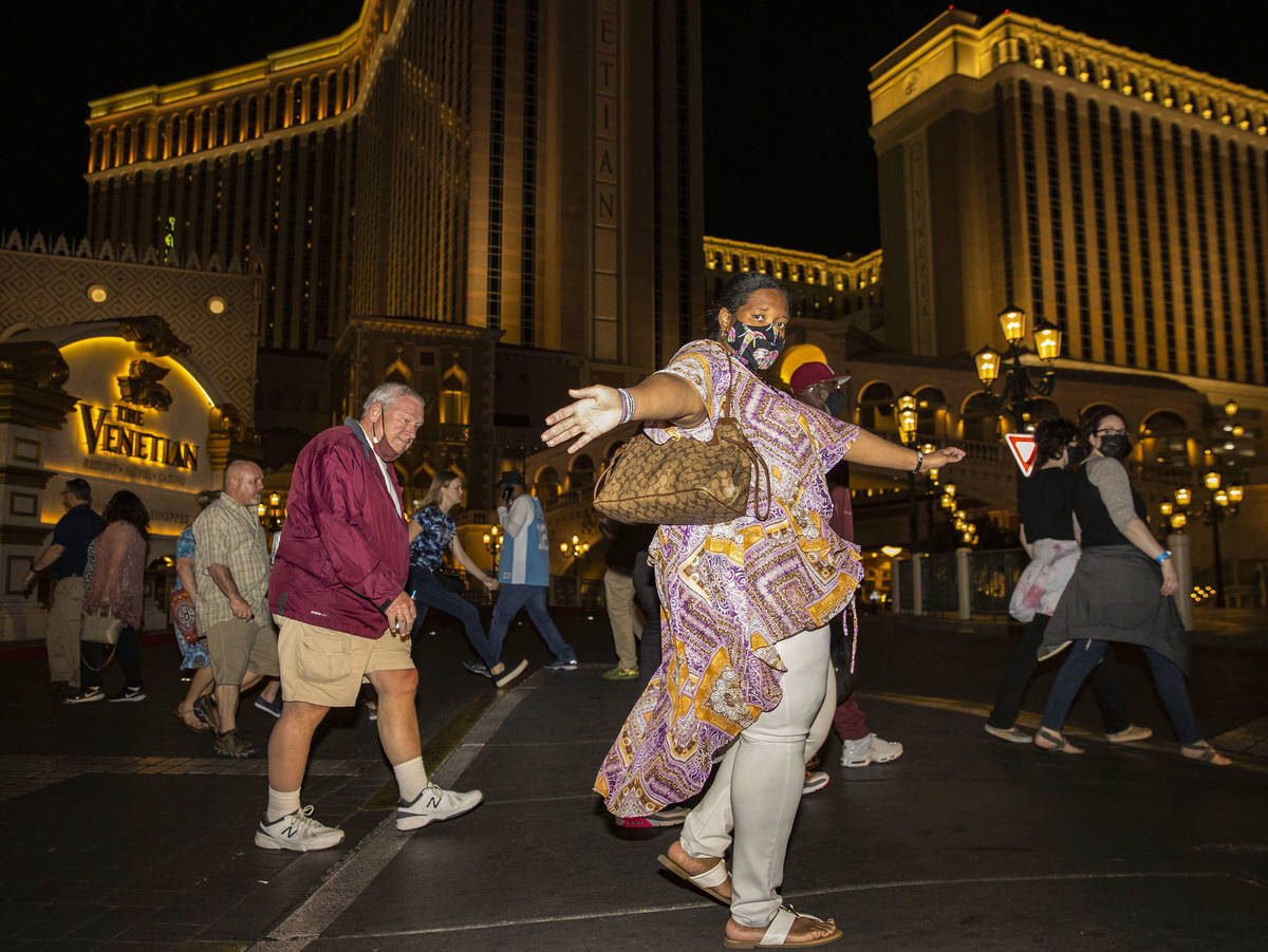 Tourists walk along Las Vegas Boulevard near The Venetian on the Strip, on Friday, March, 19, 2 ...