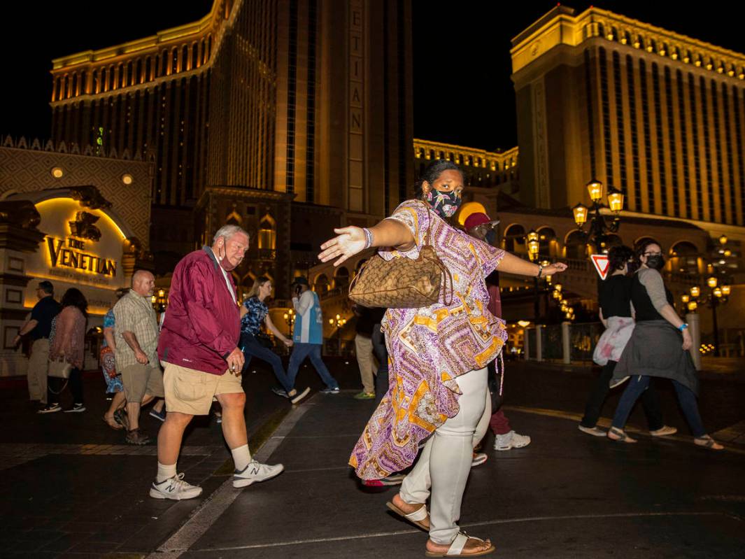 Tourists walk along Las Vegas Boulevard near The Venetian on the Strip, on Friday, March, 19, 2 ...