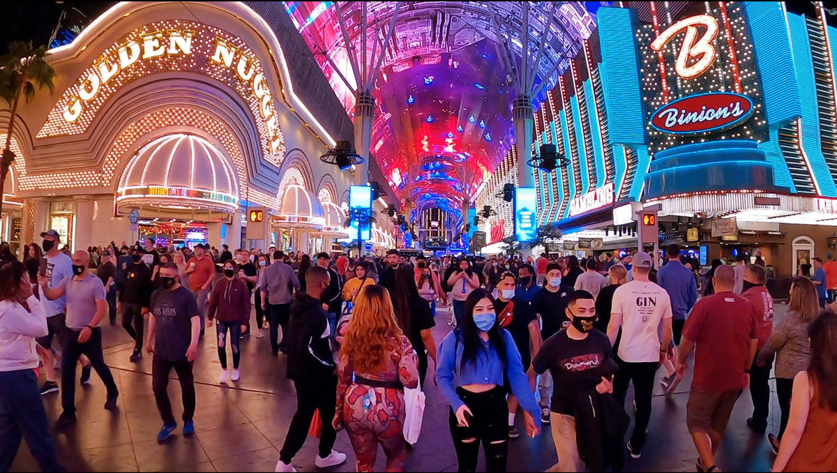 In this frame grab from video people walk along Fremont Street Experience in Las Vegas, Friday, ...