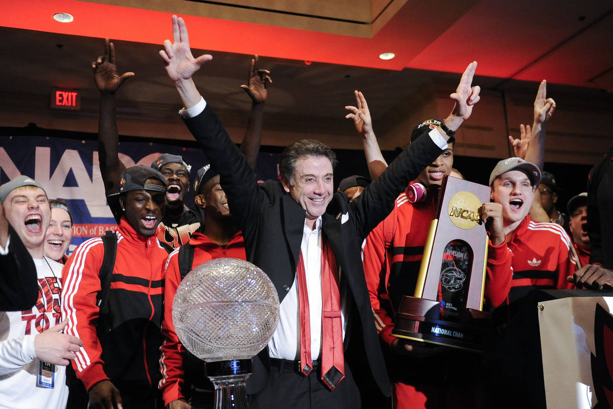 FILE - Louisville coach Rick Pitino and this team celebrate at the trophy ceremony after winnin ...