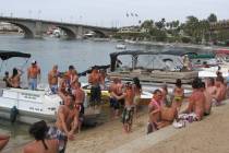 Students on spring break line the waterway in Lake Havasu City, Ariz., in 2009. (AP Photo/Felic ...