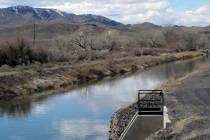 Water flows through an irrigation canal in Fernley, about 30 miles east of Reno, on Thursday, M ...