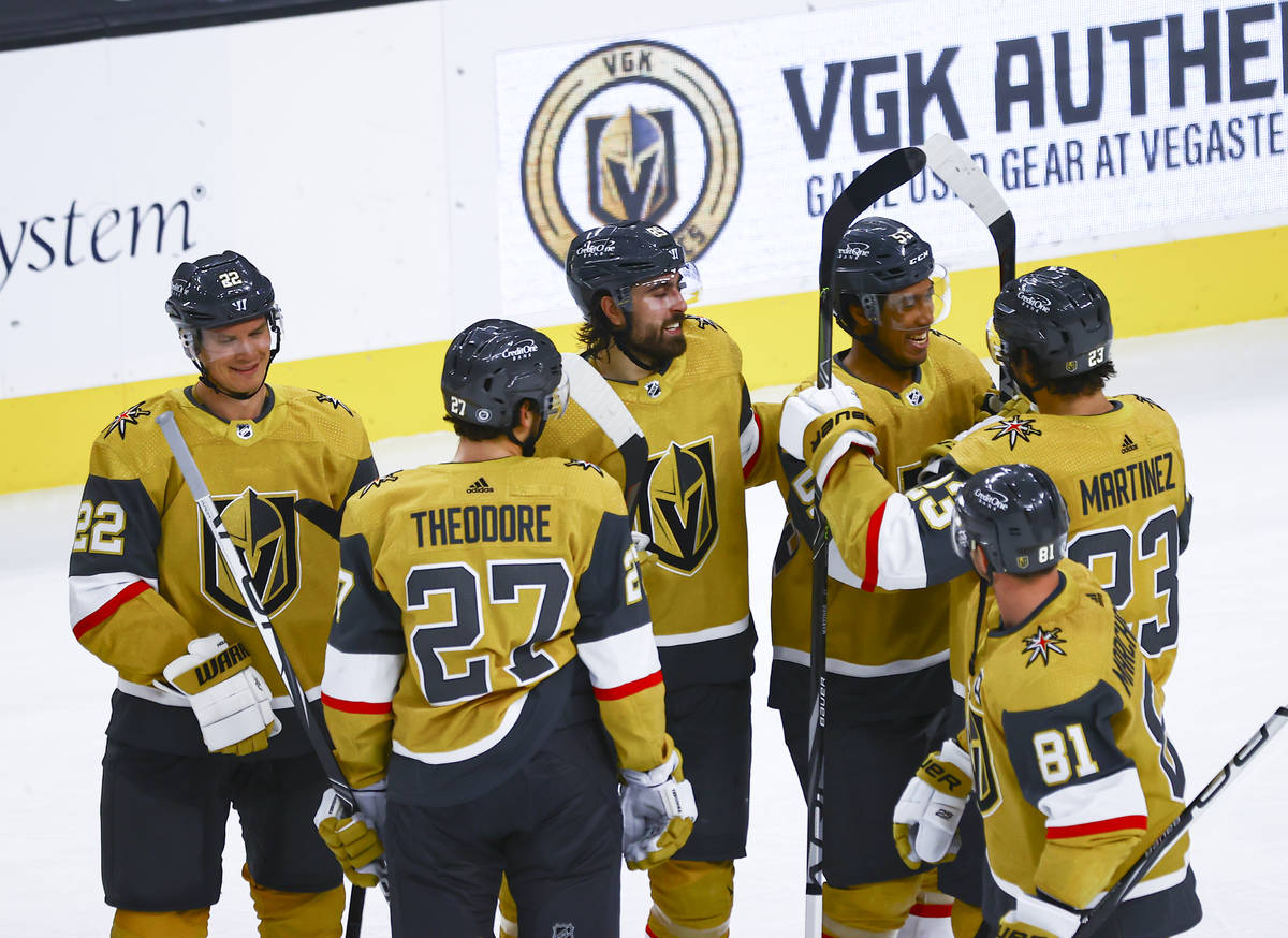 Golden Knights' Keegan Kolesar, center right, celebrates with teammates after a hockey game whe ...