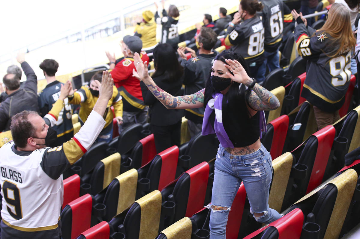 Fans celebrate after a goal by Golden Knights' Mark Stone, not pictured, against the St. Louis ...