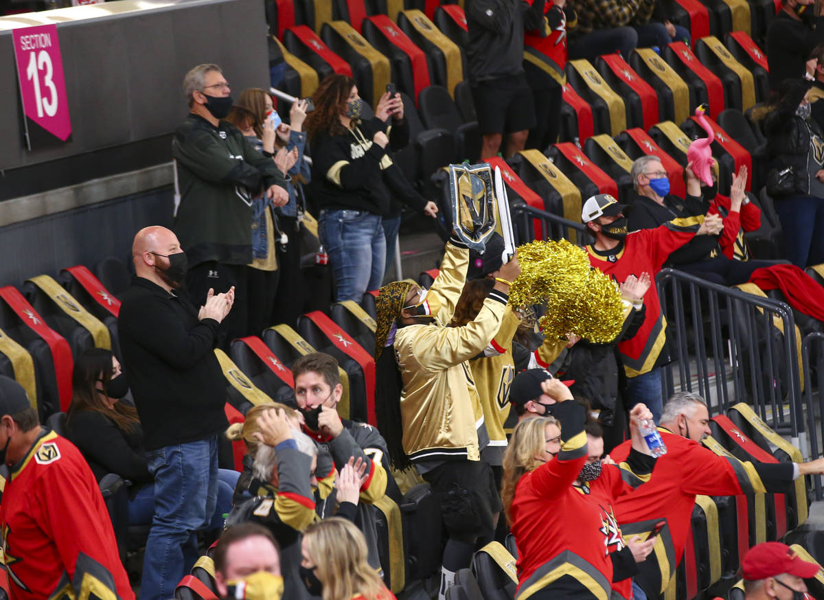 Fans celebrate after a goal by Golden Knights' Mark Stone, not pictured, against the St. Louis ...