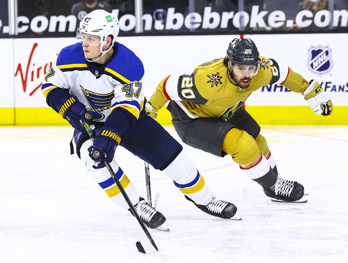 St. Louis Blues' Torey Krug (47) skates with the puck under pressure from Golden Knights' Chand ...