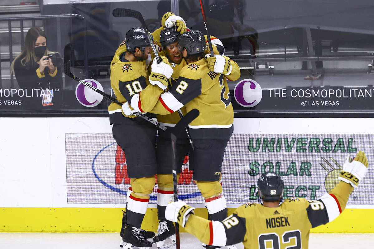 Golden Knights' Keegan Kolesar, second from left, celebrates with Nicolas Roy (10) and Zach Whi ...