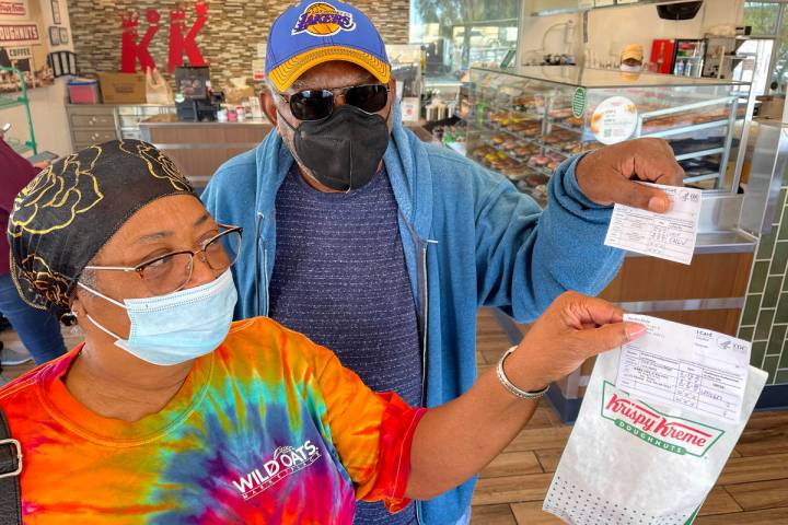 Debi and Willis Powell show their free doughnuts at Kirspy Kreme on Craig Road in North Las Veg ...