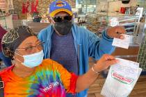 Debi and Willis Powell show their free doughnuts at Kirspy Kreme on Craig Road in North Las Veg ...