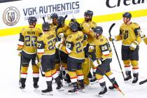 Golden Knights' Keegan Kolesar, upper left, celebrates with teammates after a hockey game where ...