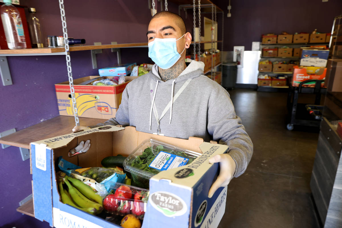 Food Pantry Coordinator Danny Solorio loads food at the Hands of Hope Community Food Pantry at ...