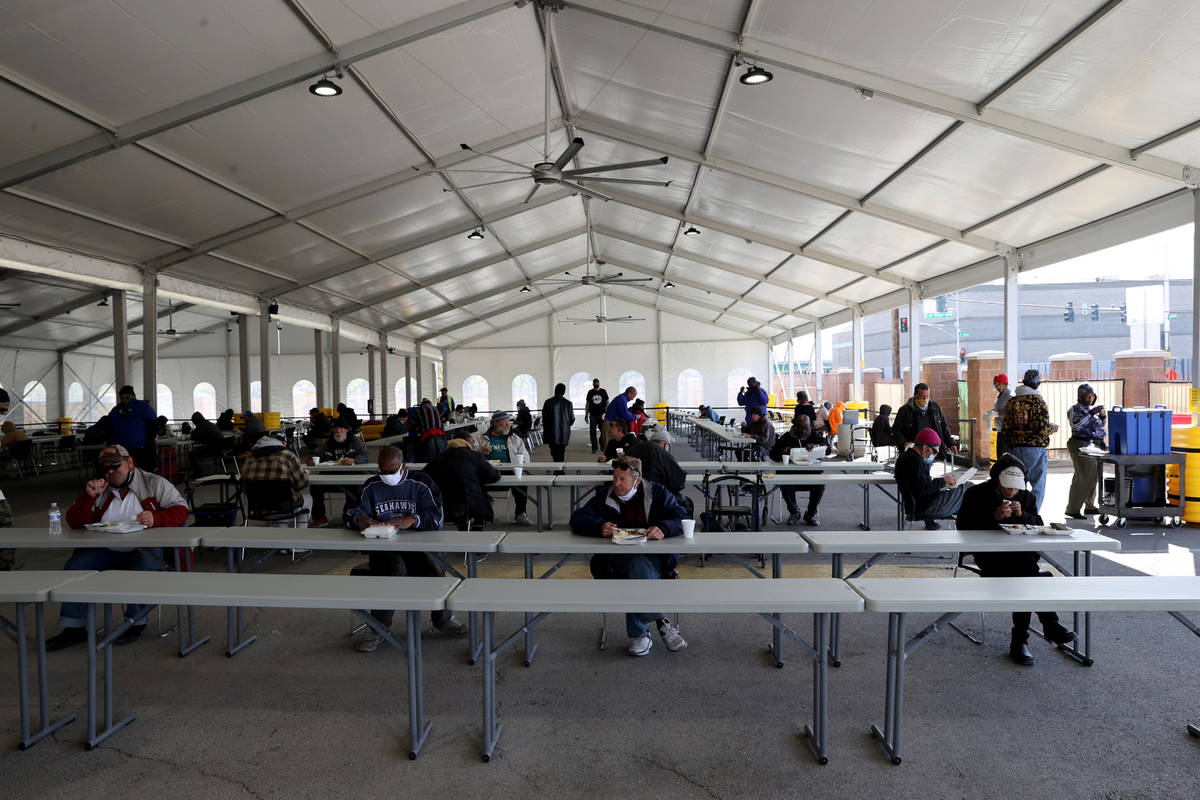 With the indoor dining hall closed due to the COVID-19 pandemic, clients dine under a tent outd ...