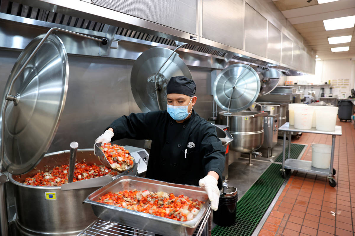 Executive Chef Jun Lao prepares food for Meals on Wheels at Catholic Charities of Southern Neva ...