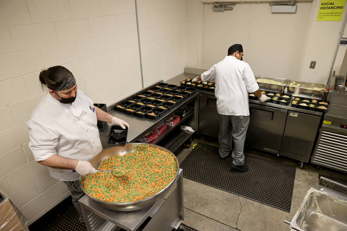 Nicholas Ray-Swonger, left, and Gustavo Ramirez prepare food for Meals on Wheels at Catholic Ch ...