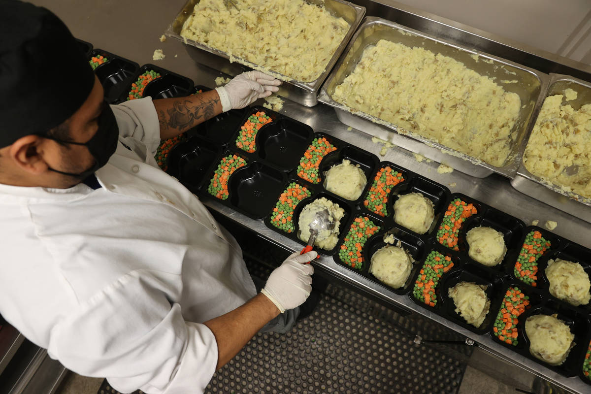 Gustavo Ramirez prepares food for Meals on Wheels at Catholic Charities of Southern Nevada in L ...