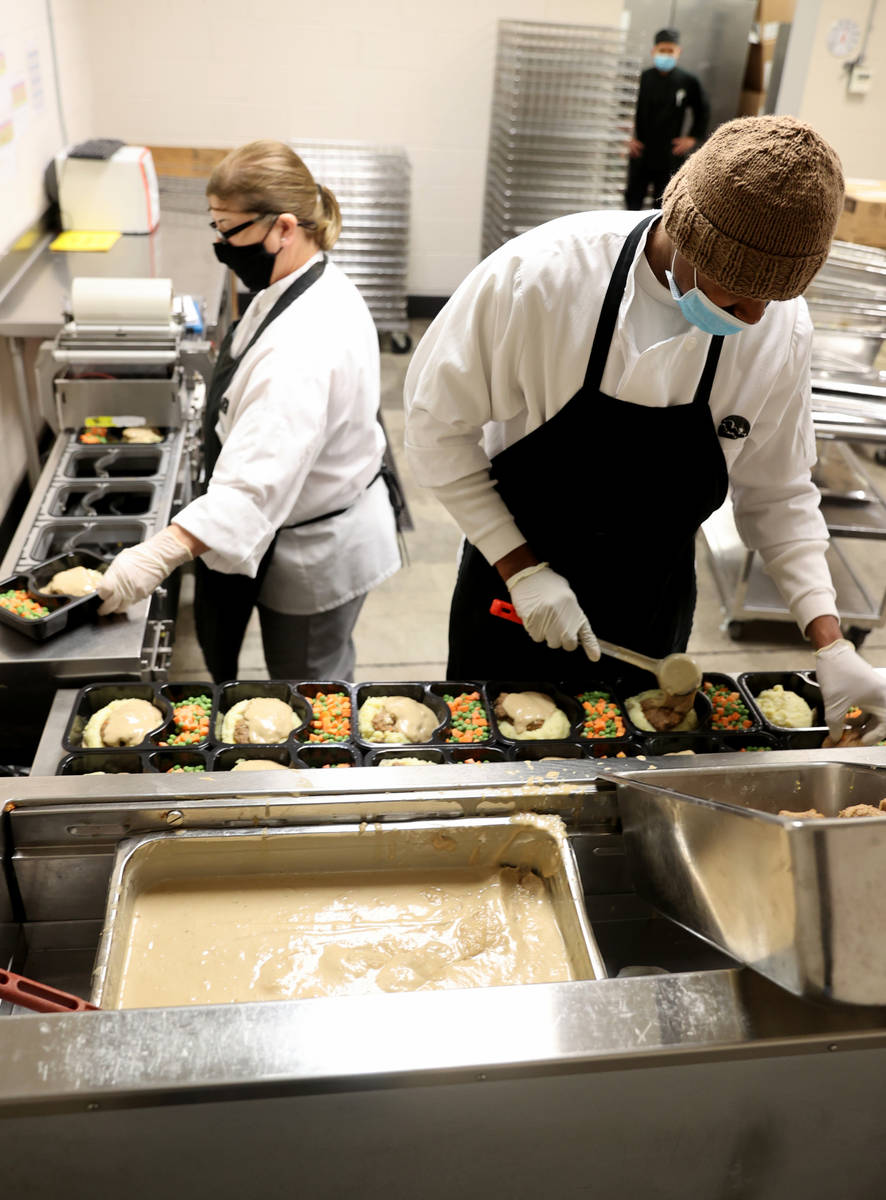 Quincy McGee, right, and Connie Valenzuela prepare food for Meals on Wheels at Catholic Chariti ...