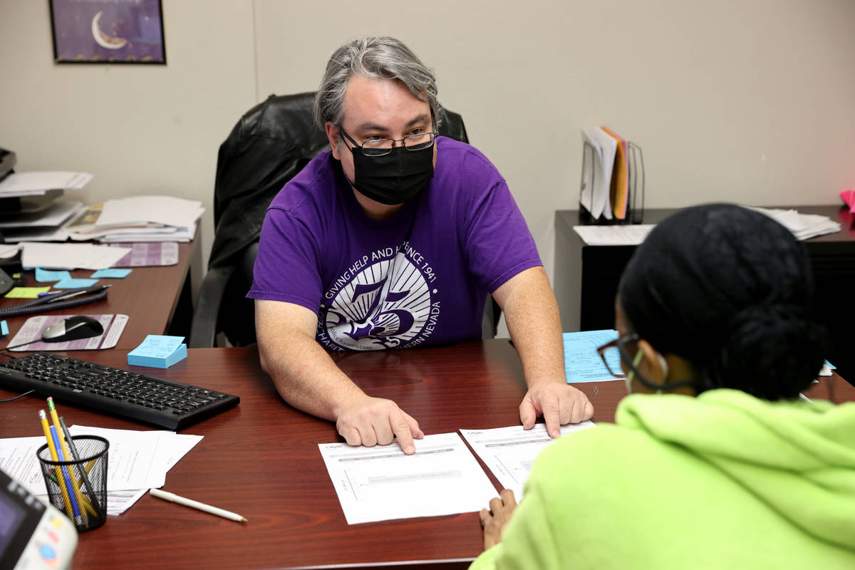 Adult Education Services Program Supervisor Robert Fink works with an unidentified client at Ca ...