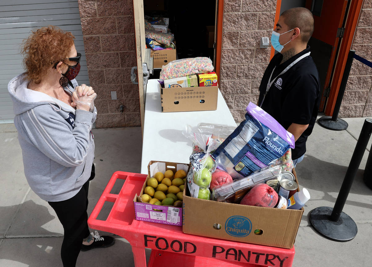 Cheryl Pritchard thanks Food Pantry Coordinator Danny Solorio as he loads food at the Hands of ...