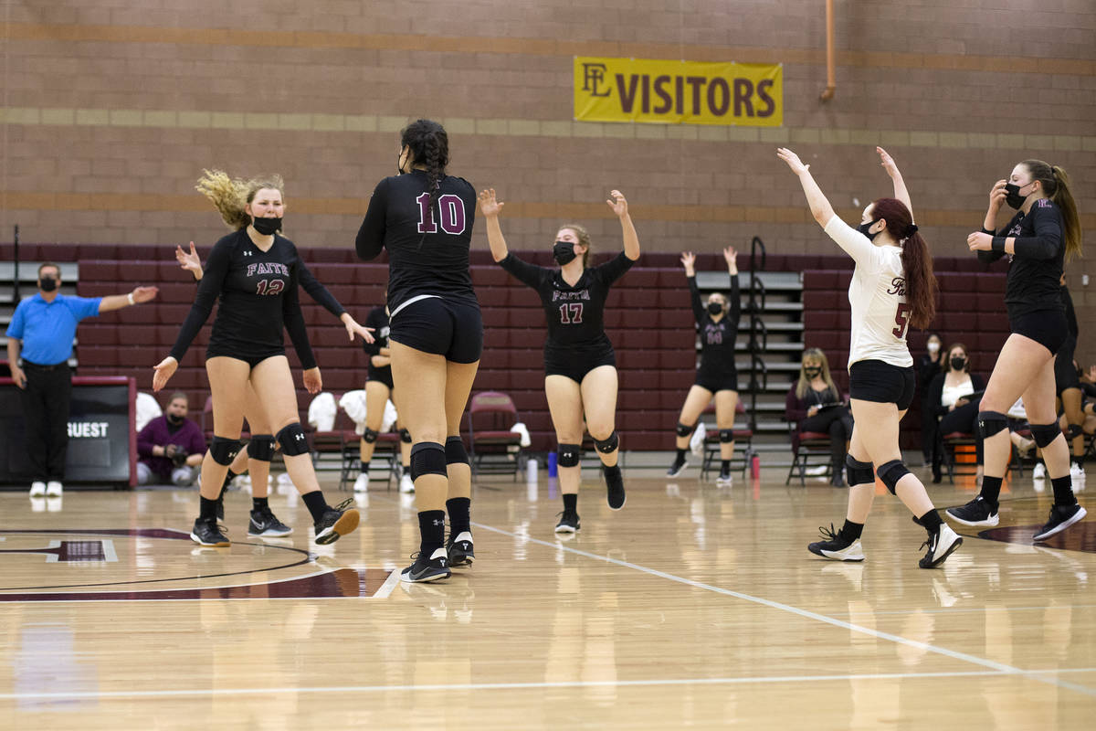 Faith Lutheran celebrates winning a match during their girls high school volleyball game agains ...