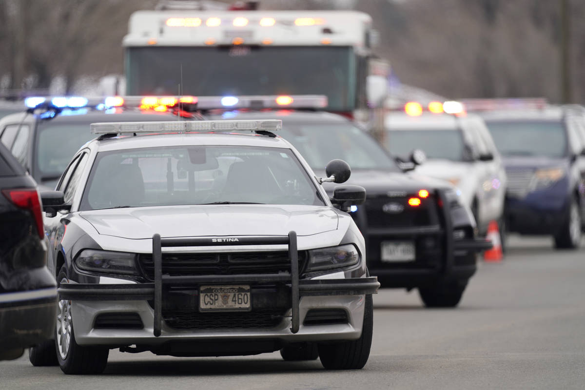 Police cars are parked outside a King Soopers grocery store where a shooting took place Monday, ...