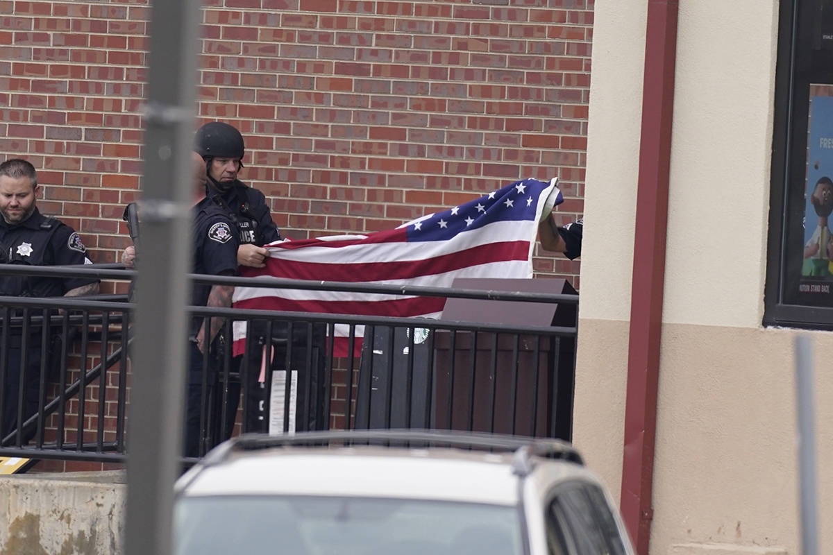 Police work on the scene outside of a King Soopers grocery store where a shooting took place Mo ...