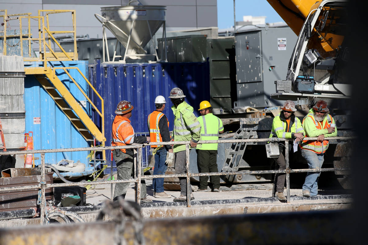 The Boring Co. workers prepare to lower the drill assembly to begin work on the second tunnel i ...