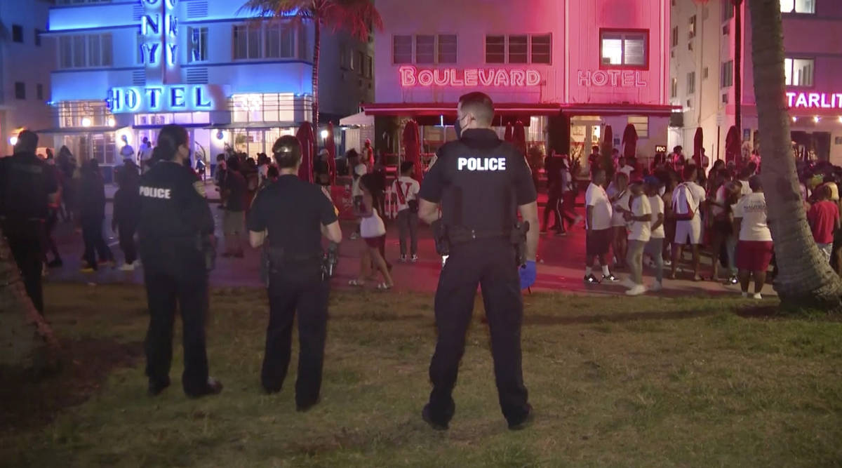 In this image taken from video, police officers stand guard March 20 as crowds descend on South ...